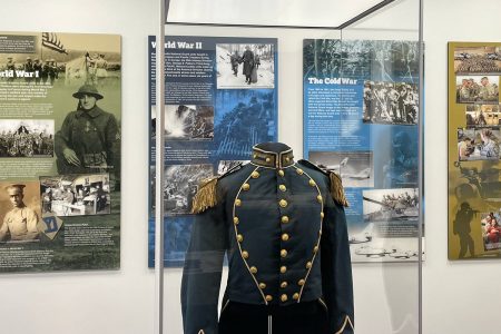 Historic military uniform displayed with war exhibits