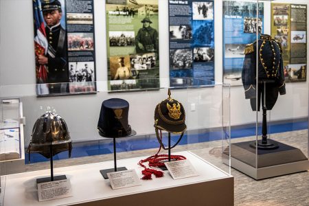 Display of historic military helmets and uniform.