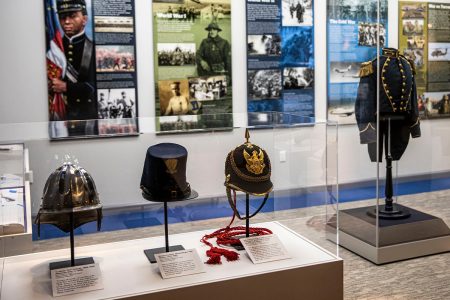 Military helmets and uniform displayed in a museum